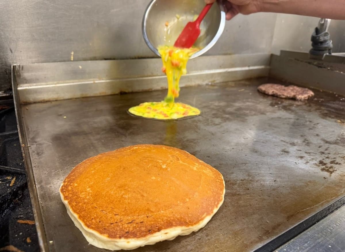 Pancakes and an omelet on the griddle