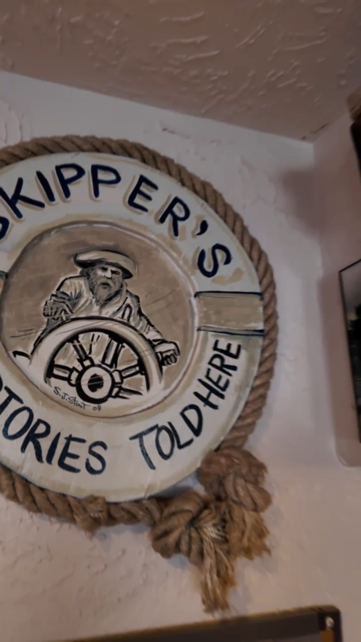 Skipper's 'Stories Told Here' ship's wheel plaque