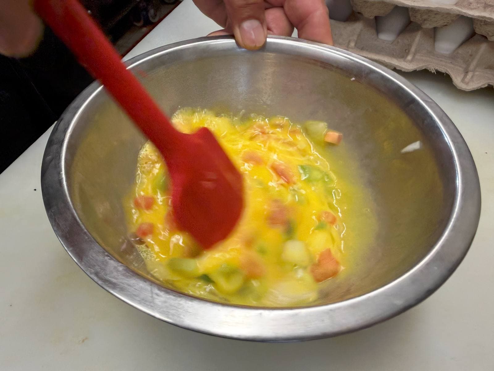 Mixing eggs by hand in the kitchen